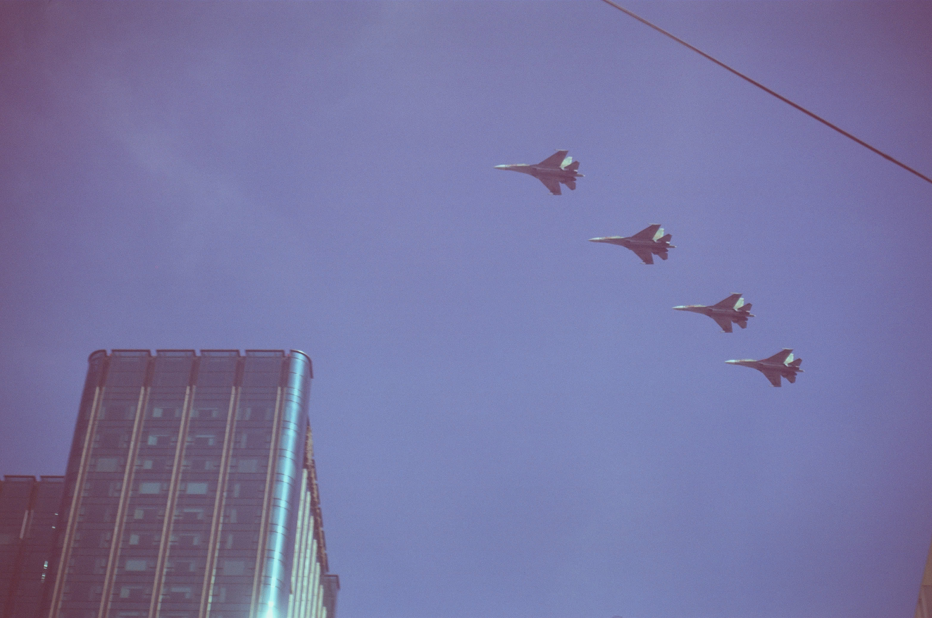 Four Su-30MK2 fighter jets flying in formation above Saigon